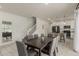 Dining area featuring a large table with seating for eight, with kitchen and stairway views at 2540 N Stone Hill Rd, Buckeye, AZ 85396