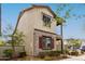 Angled view of a two-story home showcasing mixed brick and siding, and a small balcony with manicured landscaping at 2540 N Stone Hill Rd, Buckeye, AZ 85396