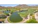 Scenic aerial view of a lush golf course with water features and mountain views at 2540 N Stone Hill Rd, Buckeye, AZ 85396