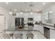 Well-lit kitchen featuring white cabinets, stainless steel appliances, granite countertops, and an island with seating at 2540 N Stone Hill Rd, Buckeye, AZ 85396