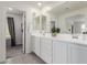 The main bathroom has double sinks, white cabinets, and large mirrors at 2540 N Stone Hill Rd, Buckeye, AZ 85396