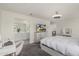 Bright main bedroom featuring a ceiling fan, dresser with TV, and a view of the en suite at 2540 N Stone Hill Rd, Buckeye, AZ 85396