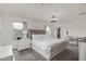 Bright main bedroom with a large bed, a ceiling fan, and a private balcony at 2540 N Stone Hill Rd, Buckeye, AZ 85396