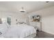Bright main bedroom featuring a ceiling fan, dresser with TV, and a private balcony at 2540 N Stone Hill Rd, Buckeye, AZ 85396