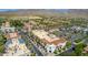 Aerial view of a bustling shopping center with ample parking and mature landscaping at 2540 N Stone Hill Rd, Buckeye, AZ 85396