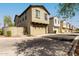 Neighborhood street featuring multiple homes, each with attached garages and well-kept landscaping at 2540 N Stone Hill Rd, Buckeye, AZ 85396