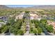 An aerial shot shows the shopping district with lush trees and the mountains in the background at 2540 N Stone Hill Rd, Buckeye, AZ 85396