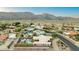 Aerial view of a desert neighborhood with mature landscaping and picturesque mountain views at 3733 E Kachina Dr, Phoenix, AZ 85044