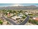 Gorgeous aerial view of neighborhood featuring a corner lot home, desert landscape and mountain views at 3733 E Kachina Dr, Phoenix, AZ 85044