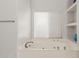 Bathroom featuring a large soaking tub and built-in shelves at 3733 E Kachina Dr, Phoenix, AZ 85044