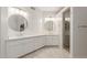 Bright bathroom featuring dual sinks, round mirrors, and a glass-enclosed shower at 3733 E Kachina Dr, Phoenix, AZ 85044