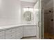 Bright bathroom featuring dual sinks, round mirrors, and a glass-enclosed shower at 3733 E Kachina Dr, Phoenix, AZ 85044