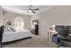 Cozy bedroom with ceiling fan, plush carpet, and bright window creating a welcoming atmosphere at 3733 E Kachina Dr, Phoenix, AZ 85044