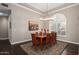 Dining room with tray ceiling, hardwood floors, and shuttered window at 3733 E Kachina Dr, Phoenix, AZ 85044
