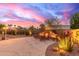 An outdoor living space features an elegant fireplace, perfect for outdoor entertaining at 3733 E Kachina Dr, Phoenix, AZ 85044