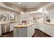 Bright kitchen with white cabinetry, stainless steel appliances, and an island with granite countertops at 3733 E Kachina Dr, Phoenix, AZ 85044