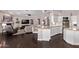 Stylish kitchen featuring granite countertops, white cabinetry, a breakfast bar, and stainless steel appliances at 3733 E Kachina Dr, Phoenix, AZ 85044