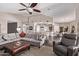 Spacious living area with a large sectional sofa, ceiling fan, and seamless flow to the kitchen at 3733 E Kachina Dr, Phoenix, AZ 85044