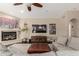 Comfortable living room with a fireplace, a ceiling fan, and a large sofa, perfect for relaxing and entertaining at 3733 E Kachina Dr, Phoenix, AZ 85044
