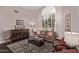 Inviting living room featuring stylish furniture, a patterned rug, and a large window with bright natural light at 3733 E Kachina Dr, Phoenix, AZ 85044