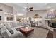 Bright, open-concept living room with a vaulted ceiling, fireplace, and view of the dining area and kitchen at 3733 E Kachina Dr, Phoenix, AZ 85044
