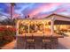 Entertain in this outdoor bar area, beautifully lit and conveniently located near the outdoor kitchen at 3733 E Kachina Dr, Phoenix, AZ 85044