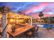 The covered outdoor bar features seating and is ideal for entertaining guests near the pool area at 3733 E Kachina Dr, Phoenix, AZ 85044