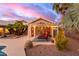 Comfortable covered patio with lounge chairs, cafe lights and access to the backyard and pool at 3733 E Kachina Dr, Phoenix, AZ 85044