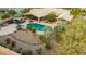 Aerial view of sparkling pool, covered patio, desert landscape and flowing rock garden at 3733 E Kachina Dr, Phoenix, AZ 85044