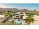 Mountain view of a backyard oasis, pool, and outdoor kitchen, perfect for relaxing in the desert at 3733 E Kachina Dr, Phoenix, AZ 85044