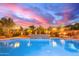 View of a sparkling pool with a brick waterfall feature and beautiful desert landscaping at 3733 E Kachina Dr, Phoenix, AZ 85044