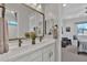 Close-up view of a well-appointed bathroom with dual sinks and a view into an adjacent bedroom at 3750 E Rochelle Cir, Mesa, AZ 85215