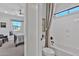 Hallway view into a bathroom showcasing a standalone tub and separate toilet area at 3750 E Rochelle Cir, Mesa, AZ 85215