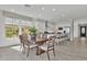 Dining area with modern table and chairs, open to kitchen with center island at 3750 E Rochelle Cir, Mesa, AZ 85215