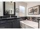 Bathroom features a bathtub, dark granite counter, and views to closet at 38662 N La Grange Ln, San Tan Valley, AZ 85140