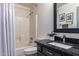 Well-lit bathroom with a shower-tub combo, a modern vanity, and stylish decorative elements at 38662 N La Grange Ln, San Tan Valley, AZ 85140