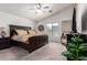 Spacious bedroom with ceiling fan, plush carpet, and a large window for natural light at 38662 N La Grange Ln, San Tan Valley, AZ 85140