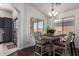 Cozy dining area with a chandelier and table seating for four at 38662 N La Grange Ln, San Tan Valley, AZ 85140