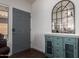 Stylish entryway with a blue cabinet, mirror, and a gray front door at 38662 N La Grange Ln, San Tan Valley, AZ 85140