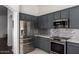 Beautiful kitchen featuring stainless steel appliances, gray cabinets and granite counters at 38662 N La Grange Ln, San Tan Valley, AZ 85140