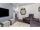 Comfortable living room with a TV, a large clock, cozy seating, and a plush rug at 38662 N La Grange Ln, San Tan Valley, AZ 85140