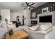 Comfortable living room with a stone fireplace, plush seating, and wood floors at 38662 N La Grange Ln, San Tan Valley, AZ 85140