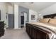 Main bedroom featuring a large wooden bed frame, neutral tones, and natural light at 38662 N La Grange Ln, San Tan Valley, AZ 85140