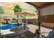 The backyard shows a patio with outdoor seating, swimming pool, and desert landscape at 43036 W Anne Ln, Maricopa, AZ 85138