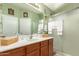 Bright bathroom featuring a shower and a vanity sink with storage cabinet at 43036 W Anne Ln, Maricopa, AZ 85138