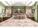 Unique bedroom features decorative canopy bed with pillows and side tables at 43036 W Anne Ln, Maricopa, AZ 85138