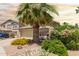 Home exterior with an attached garage, desert landscaping, and mature trees at 43036 W Anne Ln, Maricopa, AZ 85138