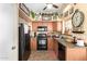 Functional kitchen with ample counter space, cabinets, and black appliances at 43036 W Anne Ln, Maricopa, AZ 85138