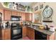 Functional kitchen with ample counter space, cabinets, and black appliances at 43036 W Anne Ln, Maricopa, AZ 85138