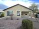 View of the backyard shows low maintenance landscaping and a covered patio area at 4440 S Leisure Way, Gilbert, AZ 85297